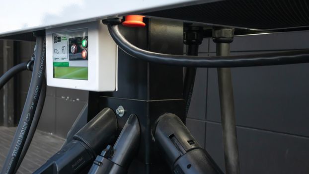 Public charging station for electric vehicles in the parking lot. Charger for public electric vehicles located in the parking lot. Ukraine, Kiev - June 14, 2021