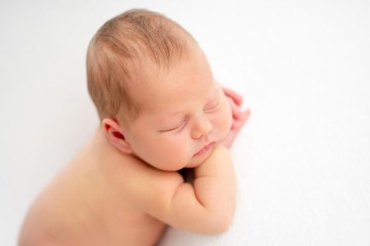 Cute newborn dreaming on light background