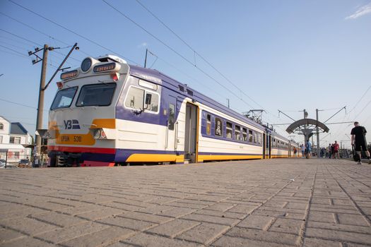 Electrical unit at the station. Passenger ring train. Kiev city train. A type of public transport in Kiev, running on a circular route within the Kiev railway junction. Ukraine, Bucha - June 28, 2021