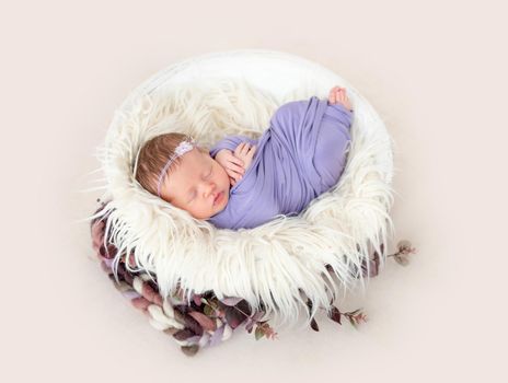 Pretty newborn baby sleeping in cradle