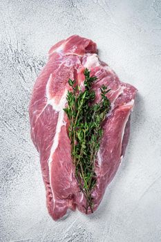 Raw pork shoulder meat on a butcher table. White background. Top view.