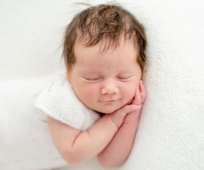 Cute newborn sleeping on stomach