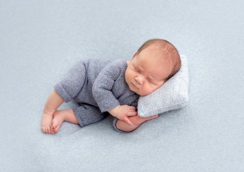 Sweet newborn sleeping on tiny pillow