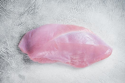 Raw whole big turkey breast fillet. White background. Top View.