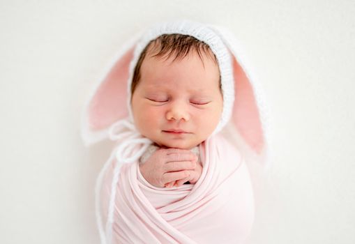 Funny newborn in knitted hat with ears