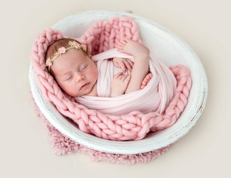 Lovely newborn sleeping with knitted toy