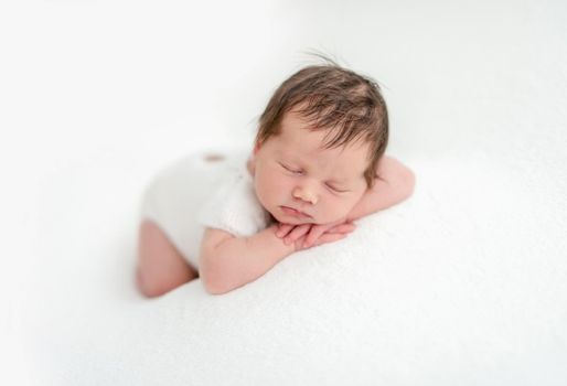 Cute newborn sleeping on stomach