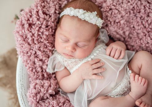 Lovely newborn sleeping with knitted toy