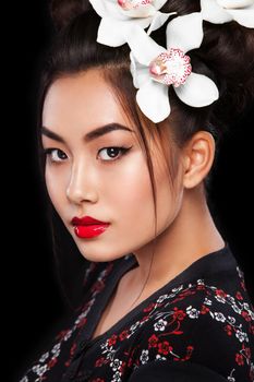 Studio fashion shot of Asian woman on black background