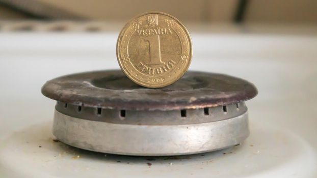 Ukrainian hryvnia on a gas water heater without fire. Gas stove with money. Conceptual image of a rising tariff for violence. Natural gas saving concept at home, high gas prices