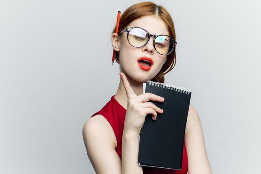 woman secretary in glasses with a notebook in the hands of the manager. High quality photo