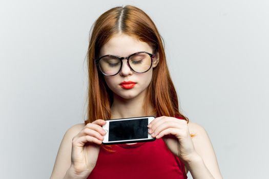 pretty woman in glasses with phone in hands communication technology. High quality photo