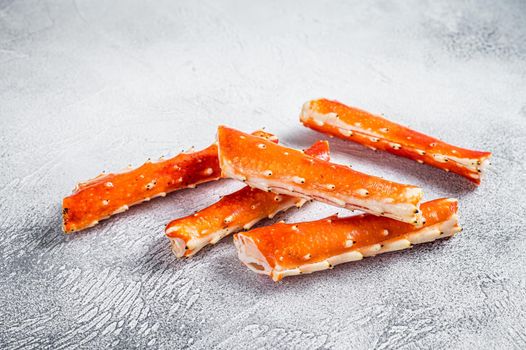 Crab legs Phalanx on a kitchen table. White background. Top view.