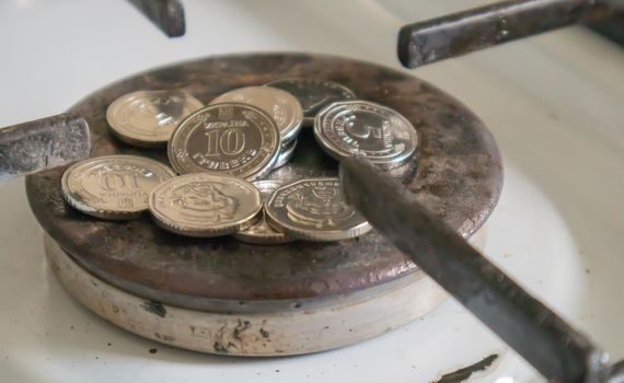 Ukrainian hryvnia on a gas water heater without fire. Gas stove with money. Conceptual image of a rising tariff for violence. Natural gas saving concept at home, high gas prices