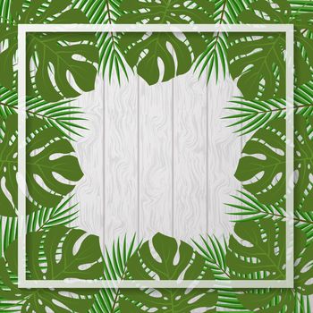 Tropical leaves on a gray wooden background. Template for posters, banners or flyers.