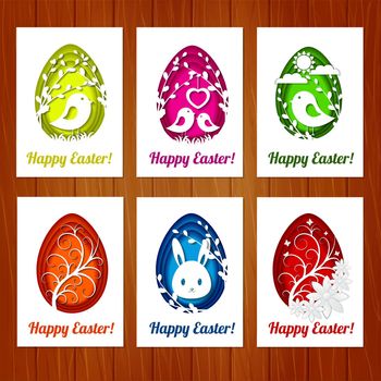 Set of Easter cards with colorful eggs in paper cutting style on wooden background. Imitation paper art style. Template for greeting Easter cards.