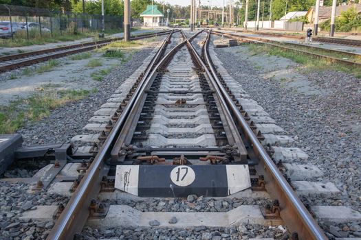 Abstract view of railway arrows. A turnout switch for rails in railway traffic. Rails, sleepers and crushed stone on the railway track. Switching transitions