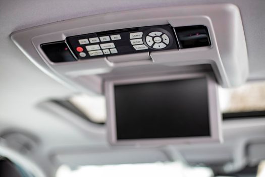 screen Interior detail of modern luxury car dashboard with big display and light button switch on ceiling. Screen multimedia system