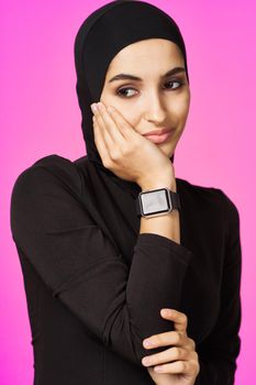 muslim woman in black hijab smart watch technology entertainment. High quality photo