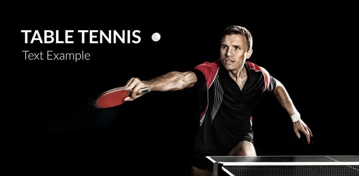 Portrait Of Young Man Playing Tennis On Black Background