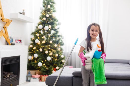 little girl cleaning the apartment before christmas