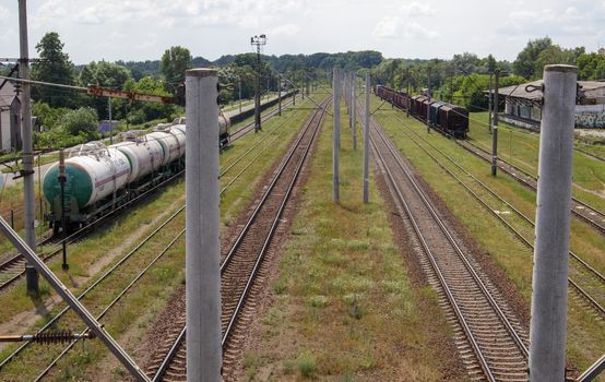 Railway stations with carriages and railroad tracks and trains, transport system. The way forward is the railroad. The modern railway infrastructure was reconstructed