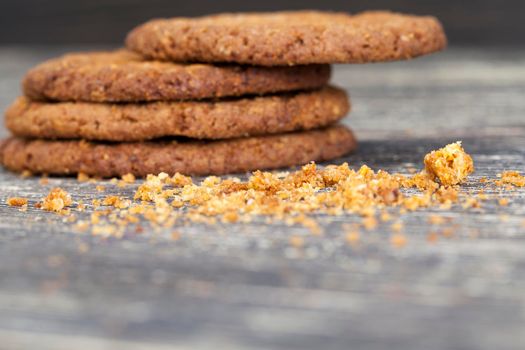 round shaped tasty oatmeal cookies round shaped lying on a wooden table, biscuits dry and crumbled