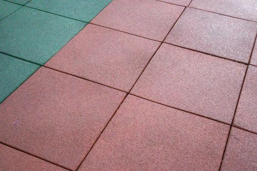 Artificial rubberized coating for playgrounds. Synthetic material. Colorful background of outdoor playground in rainy weather. Active lifestyle, workout concept