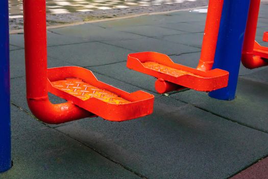 Exercise machines and fitness equipment for exercising on an open air sports ground in cloudy rainy weather without people