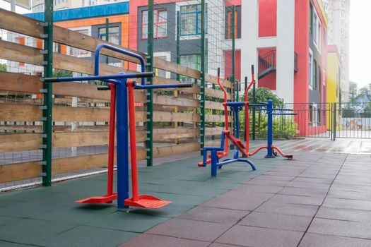 Exercise machines and fitness equipment for exercising on an open air sports ground in cloudy rainy weather without people