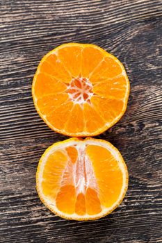 delicious tangerines, peeled orange peel lying on a wooden table, healthy citrus fruits with lots of vitamins