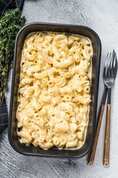 Mac and cheese american macaroni pasta with cheesy Cheddar sauce. White background. Top view.