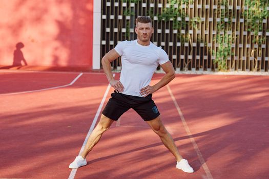 man on the sports ground exercise warm-up lifestyle. High quality photo