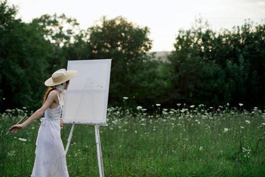 pretty woman in white dress outdoors drawing art creative. High quality photo