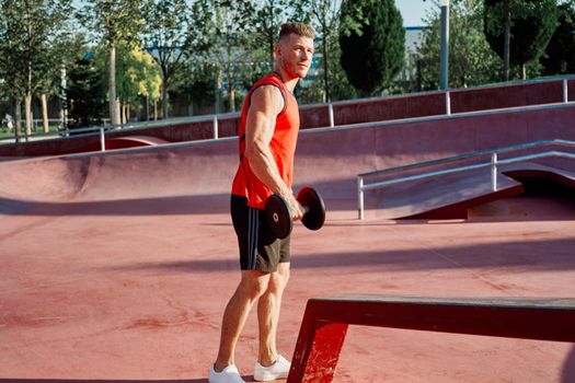 athletic man in red jersey workout exercise pumped up body. High quality photo