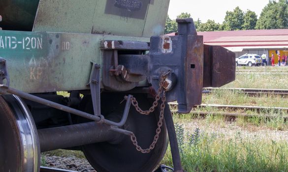 Train carriage on rails. Outdated technology for joining freight train wagons. Oil cargo hitch body for docking. A rail car coupling that connects it to other carriages on the train