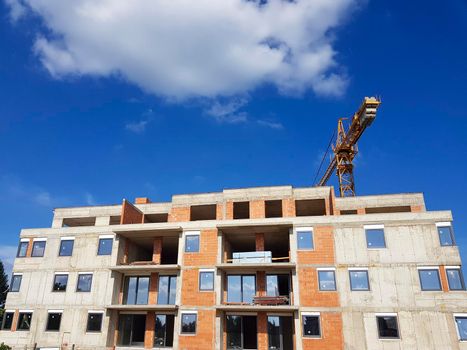 Construction of the building. A crane can be seen in the background. downwards. Constraction yard.