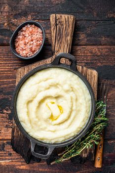 Mashed potatoes in a pan on wooden rustic table. Wooden background. Top view.