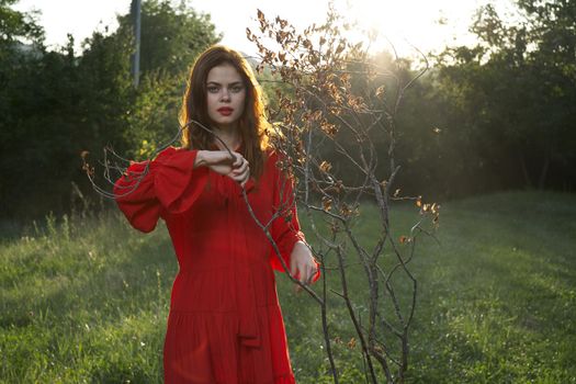 attractive woman in red dress outdoors fresh air summer. High quality photo