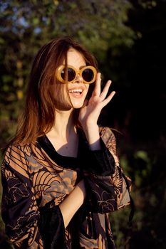 pretty woman wearing sunglasses outdoors fashion nature. High quality photo