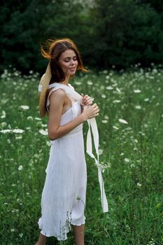 Woman in white dress flowers nature walk charm. High quality photo