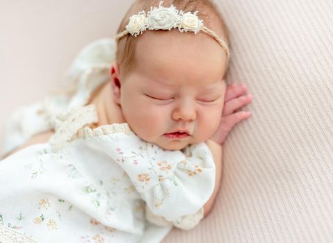 Peaceful dream of charming newborn baby girl