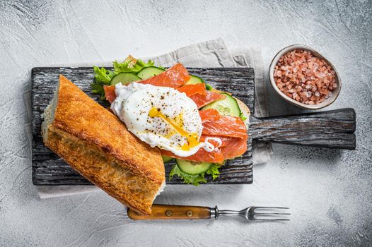 Sandwich with Poached egg, smoked salmon and avocado on toast. White background. Top view.