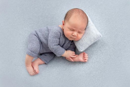 Sweet newborn sleeping on tiny pillow