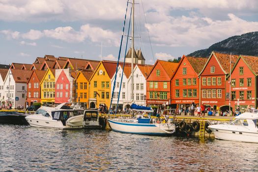 Bergen, Norway. View of historical buildings in Bryggen. Hanseatic wharf in Bergen, Norway July 28, 2019. UNESCO. Famous Bryggen street with wooden colored houses in Bergen Akerbrygge distric.