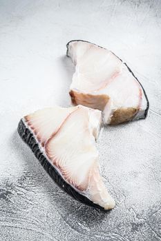 Raw Shark fish steaks on a kitchen table. White background. Top view.