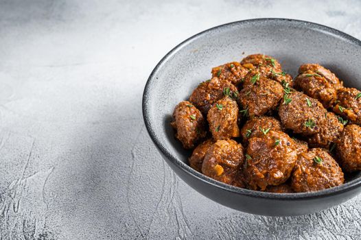 Fried Meatballs in tomato sauce from ground beef and pork meat. White background. Top view. Copy space.