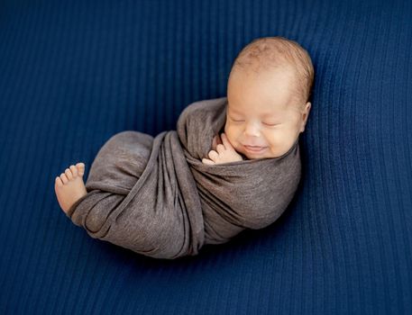 Comfortable pose of sleepy newborn