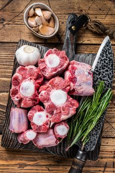 Raw beef Oxtail cut Meat on wooden cutting board with knife. wooden background. Top view.