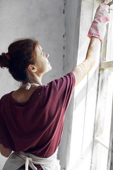 woman paints the window in the room interior renovation decoration. High quality photo